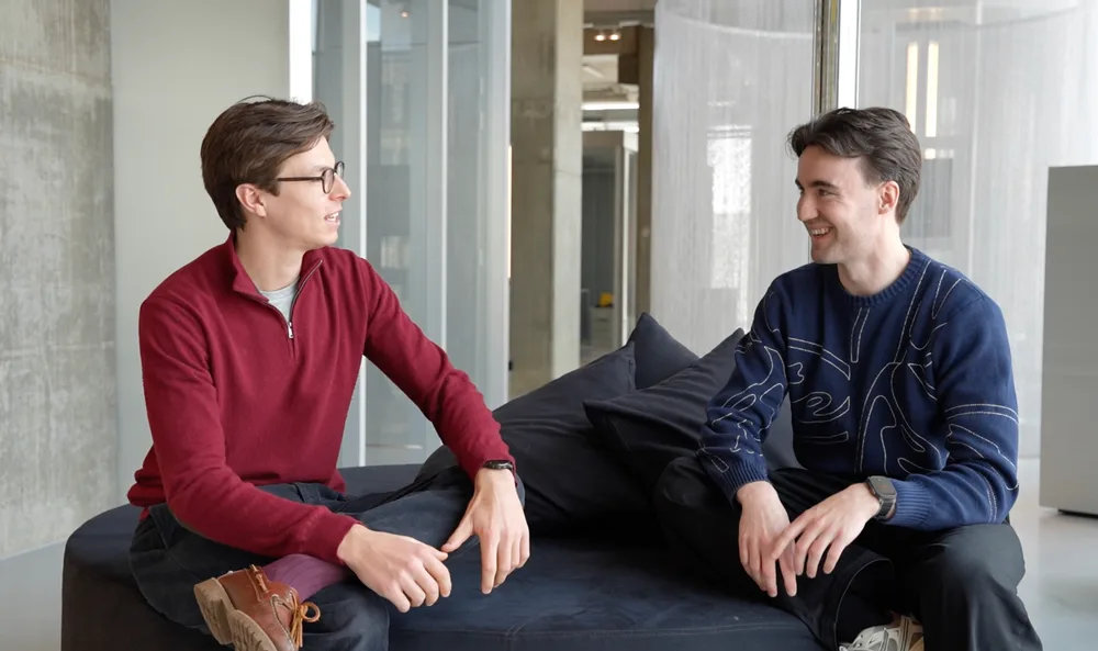 Two Conveo engineers in conversation on the office couch