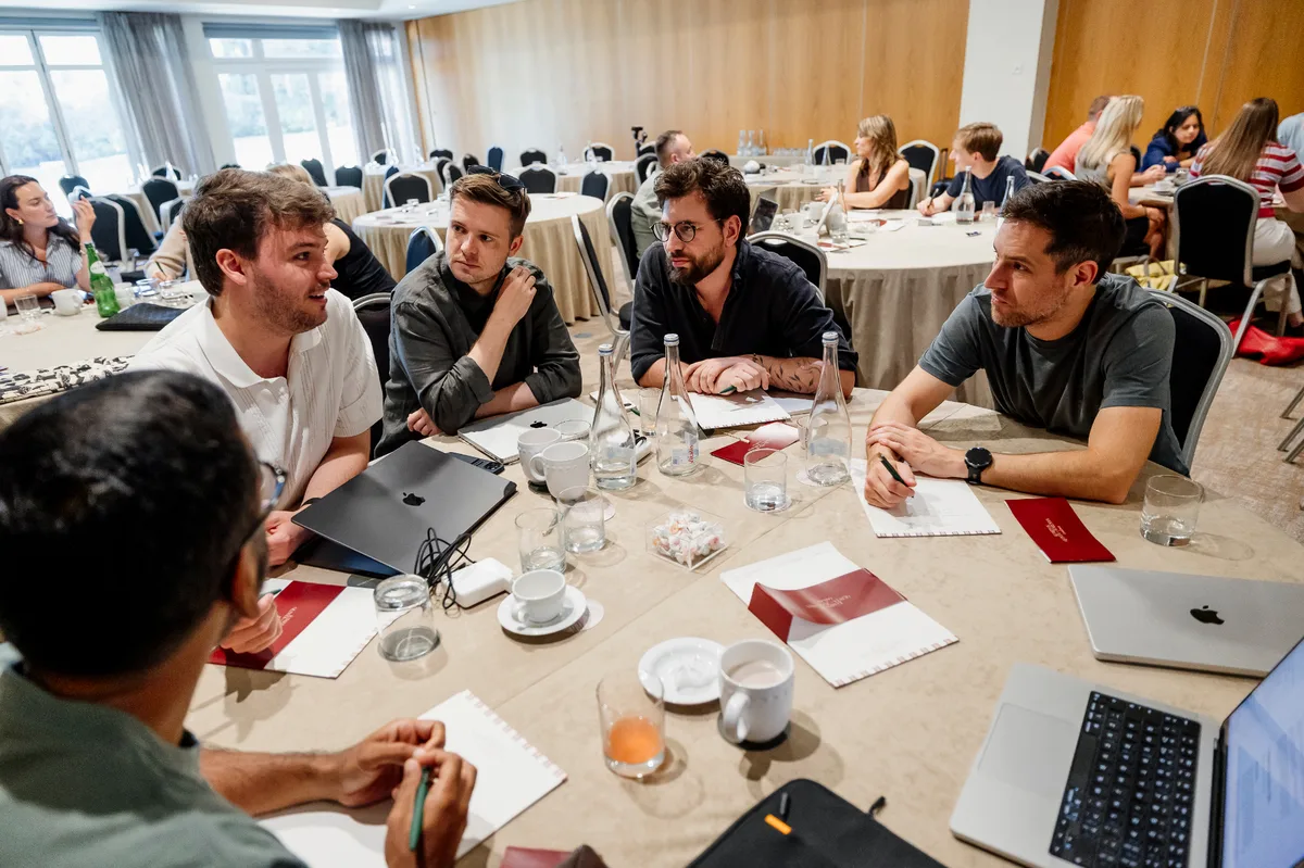 Engineers collaborating at a table during a team offsite