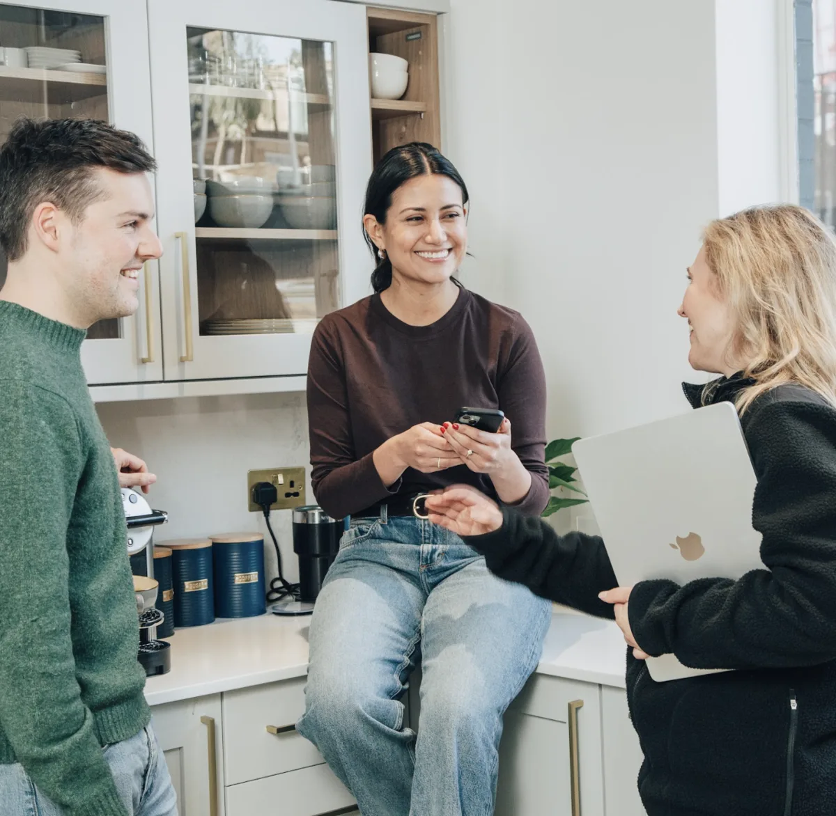 Conveo team talking in the office kitchen