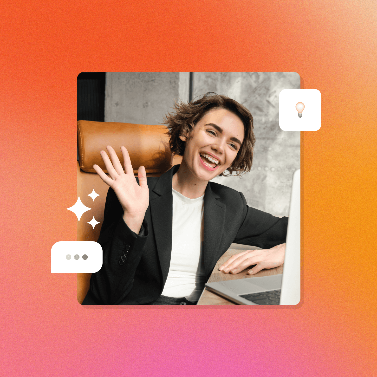 A lifestyle photo graphic on a warm orange-to-pink gradient background. A smiling woman in a black blazer over a white top waves at the camera while seated in a leather chair next to a laptop, photographed against a concrete wall. Three decorative UI elements are overlaid on the image: a white speech bubble with three dots (indicating a conversation) on the lower left, a white four-pointed sparkle icon on the middle left, and a small white rounded card with a lightbulb emoji on the upper right.