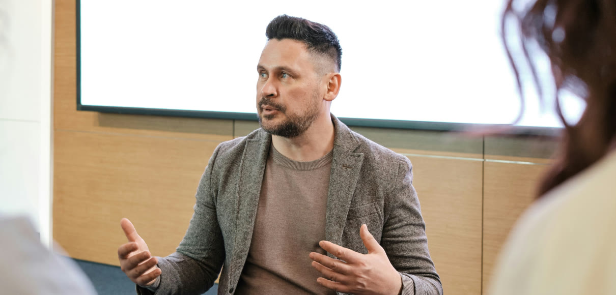 A marketing lead talking through a campaign in a meeting