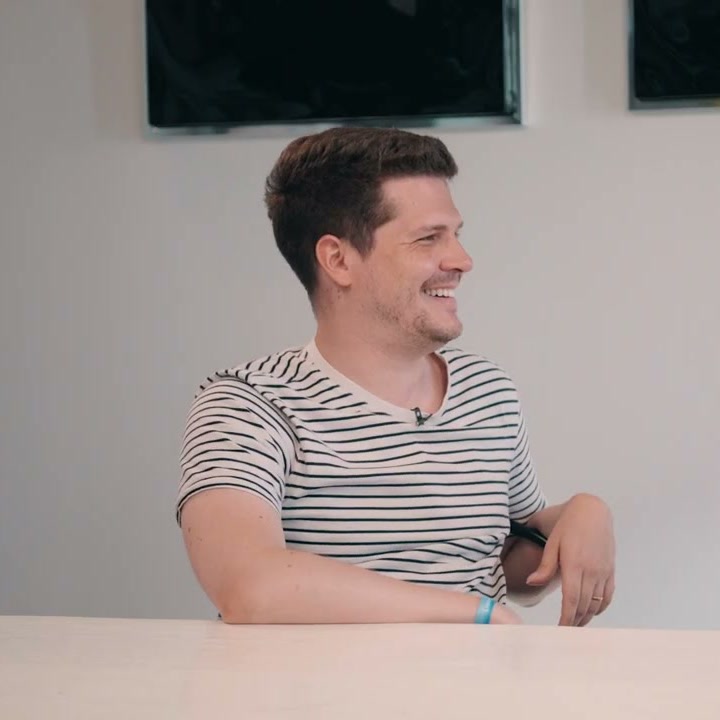 Dieter De Mesmaeker in a striped T-shirt smiling at the table on the Conveo podcast set at Cannes Lions 2026