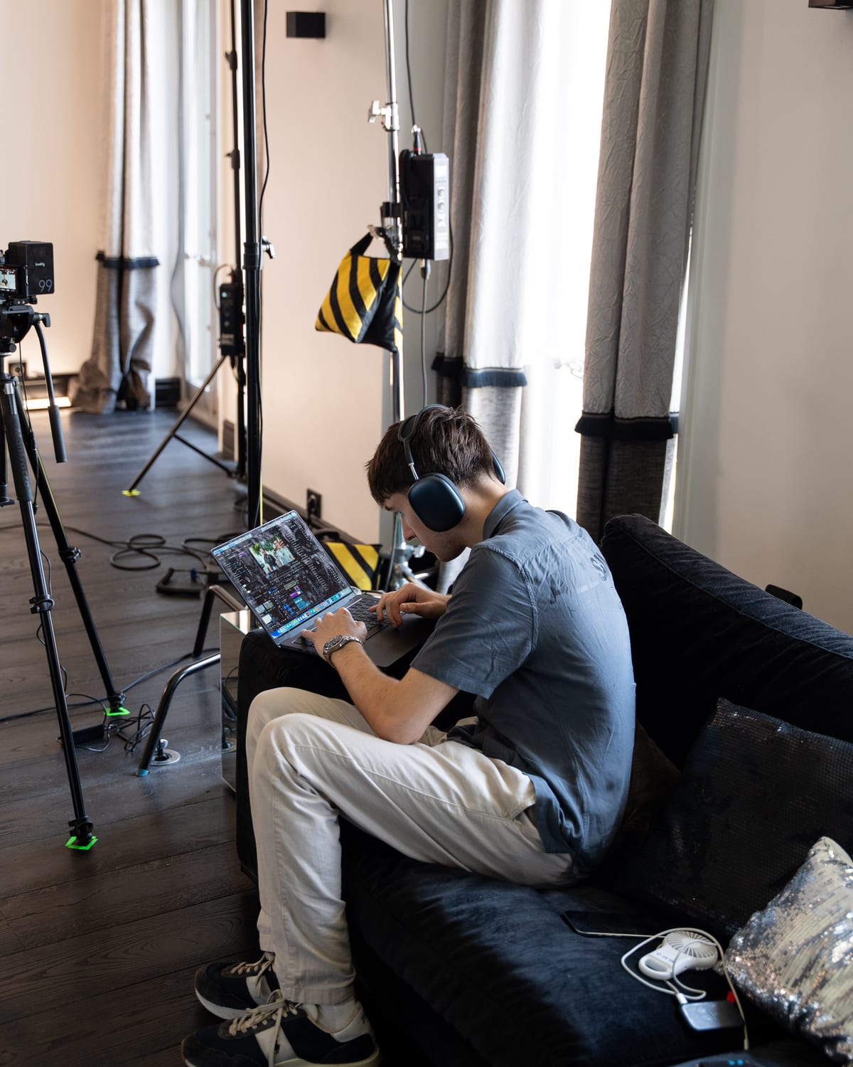 A crew member seated among camera rigs, checking footage on the Conveo podcast set at Cannes Lions 2026.