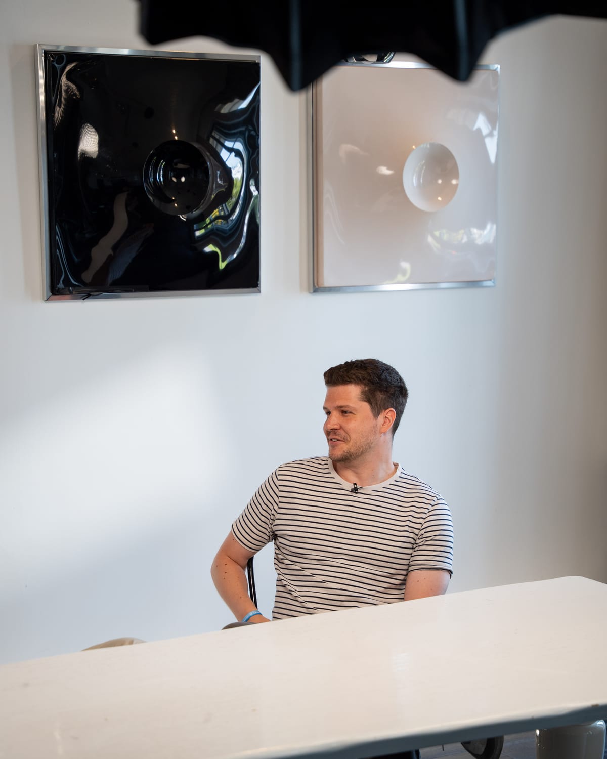 Dieter De Mesmaeker in a striped T-shirt resting his arms on the table on the Conveo podcast set at Cannes Lions 2026.