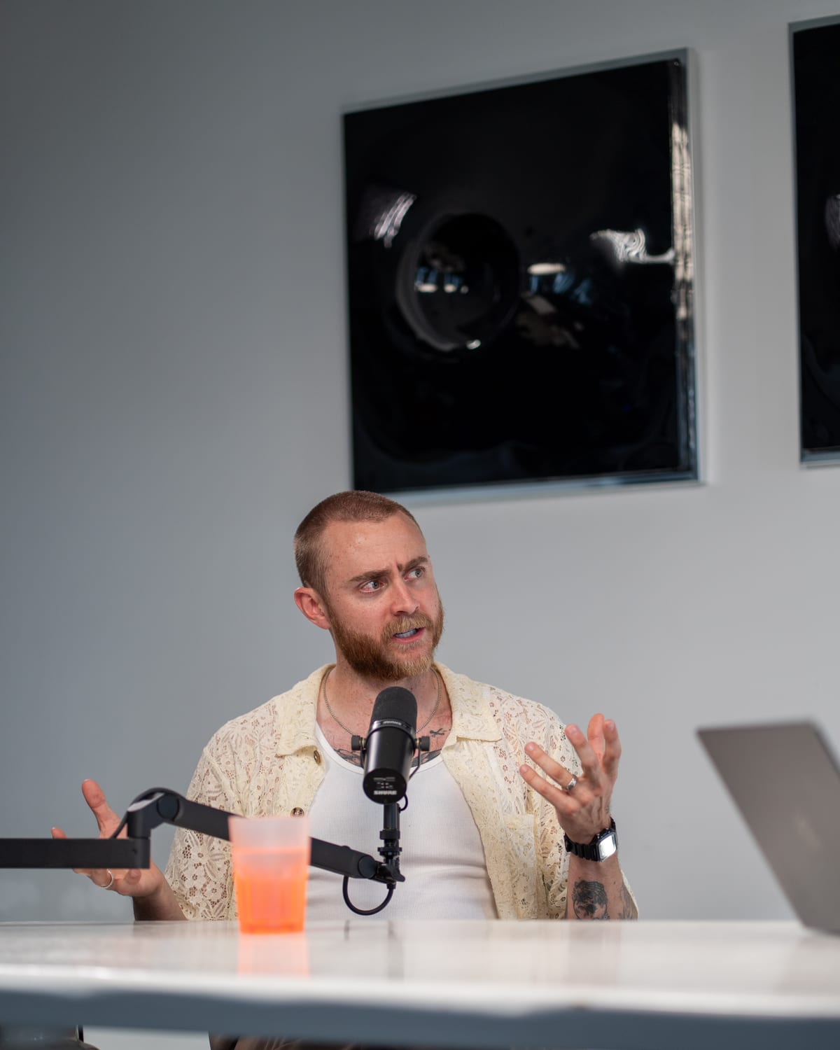 Brock Johnson gestures with one hand as he speaks into the microphone on the Conveo podcast set at Cannes Lions 2026.