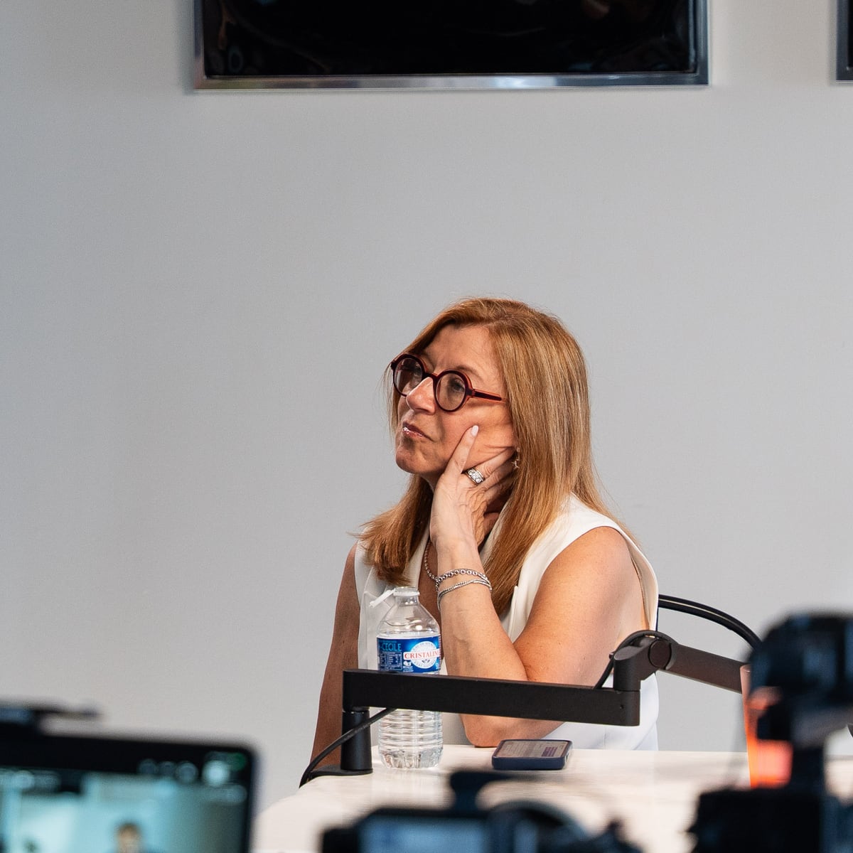 Carole Irgang listening with her hand at her chin on the Conveo podcast set at Cannes Lions 2026