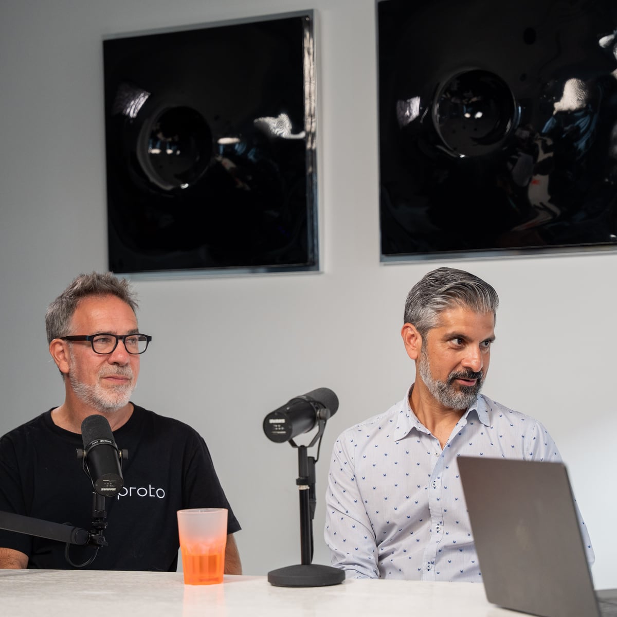 Proto co-founders Saneel Radia and Barry Wacksman side by side at the microphones on the Conveo podcast set at Cannes Lions 2026