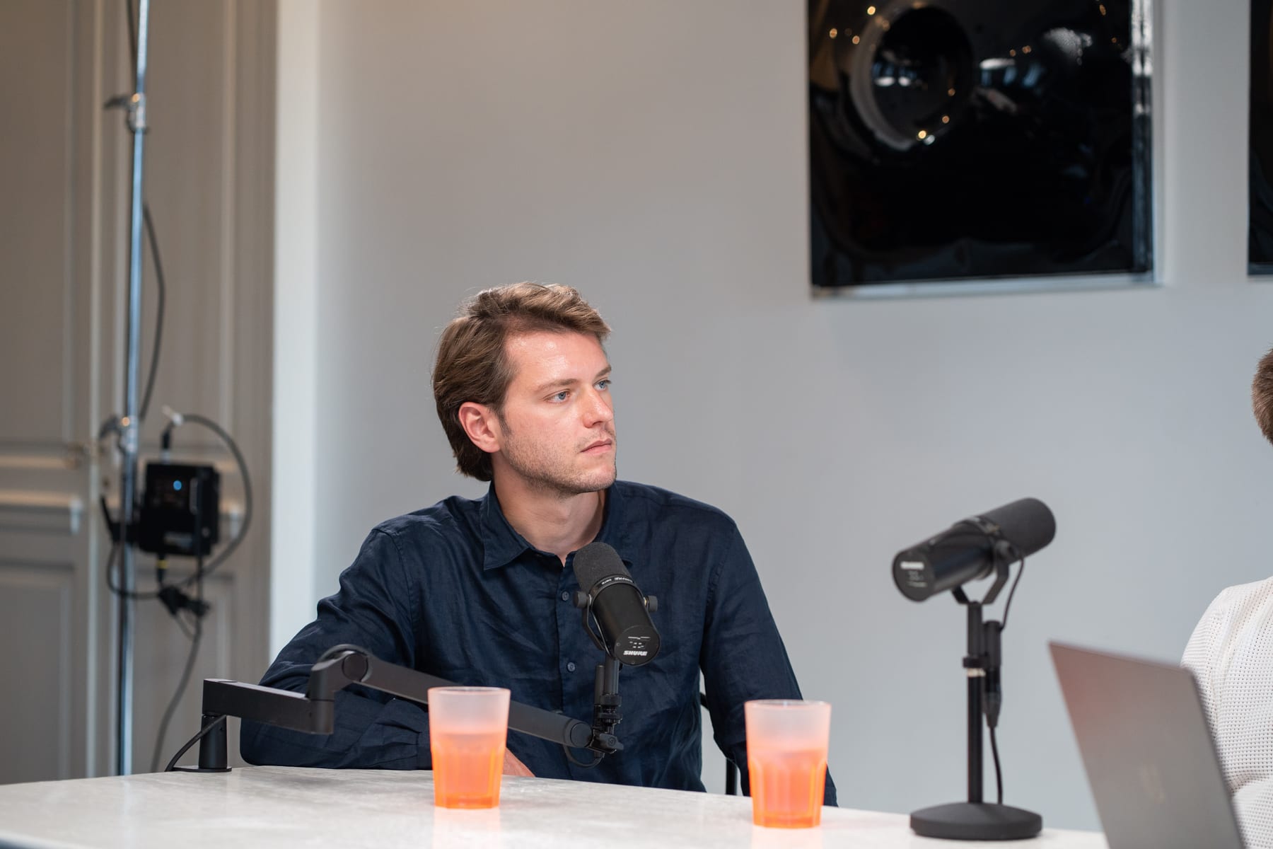 Conveo co-founder Hendrik Van Hove in a navy shirt speaking into a studio microphone on the podcast set at Cannes Lions 2026