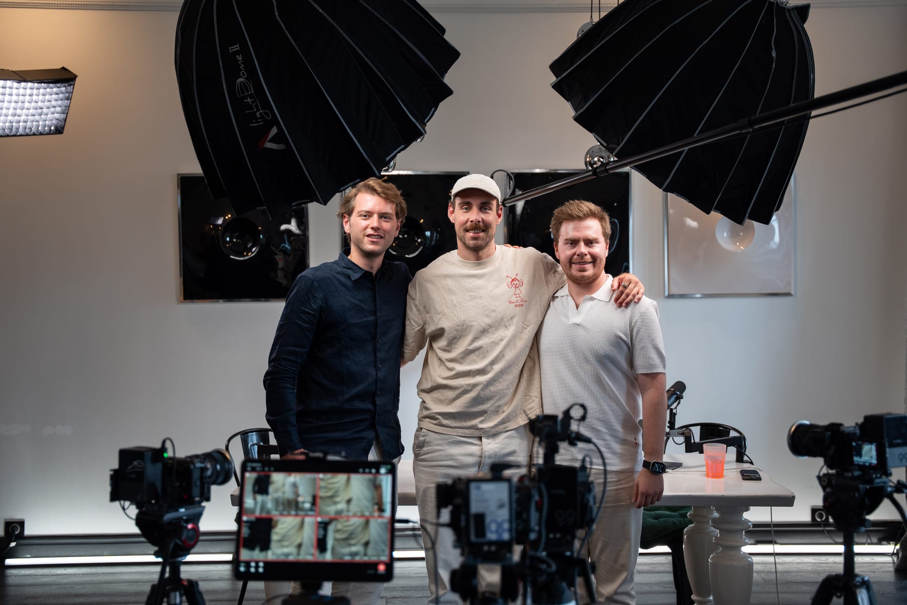 Hendrik Van Hove, a third person in a cap and Doug Tallmadge posing together on the Conveo podcast set after the recording at Cannes Lions 2026