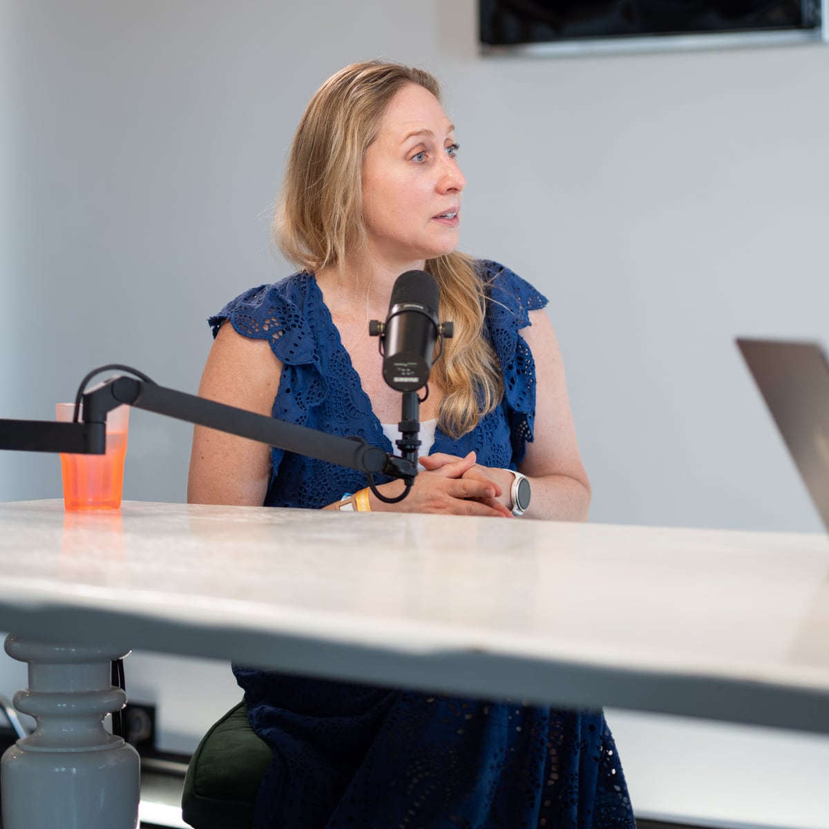 Karen Ehrlich of The Estée Lauder Companies at the microphone on the Conveo podcast set at Cannes Lions 2026
