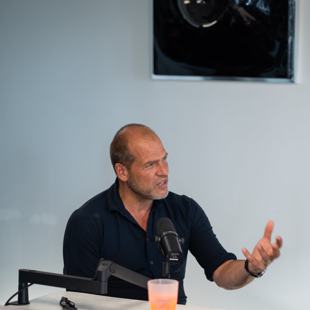 Kees Kruythoff in a dark shirt gesturing as he talks at the microphone on the Conveo podcast set at Cannes Lions 2026