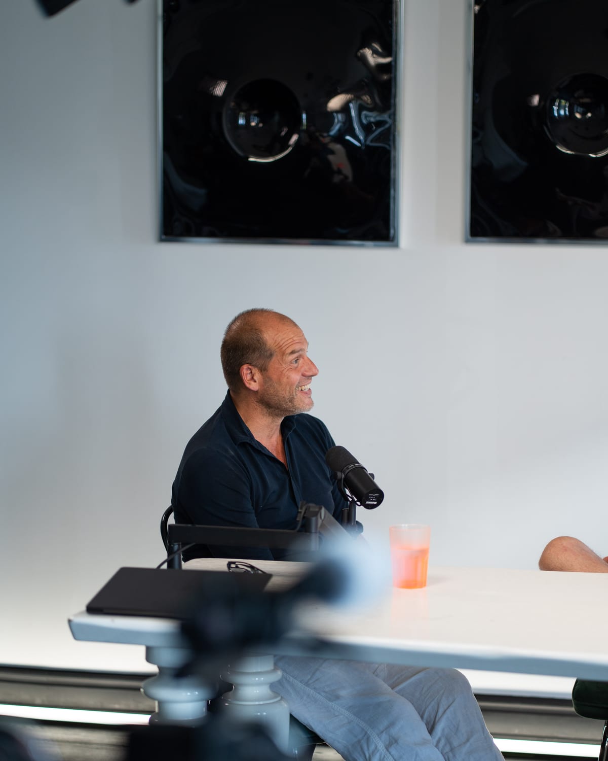 Kees Kruythoff smiling at the microphone at the end of the podcast table at Cannes Lions 2026