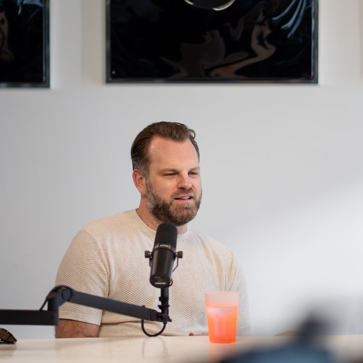 Matt Hammel of AirOps speaking into a microphone on the Conveo podcast set at Cannes Lions 2026