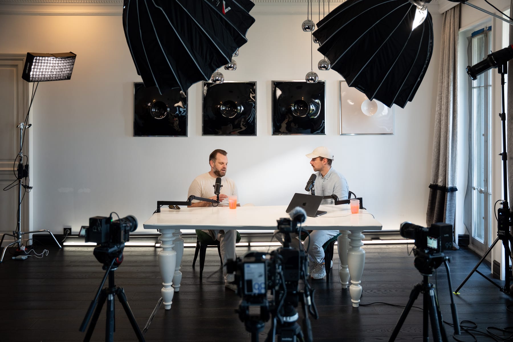 Wide view of the Conveo podcast set with Matt Hammel and the host at a white table, surrounded by cameras, softboxes and lights at Cannes Lions 2026