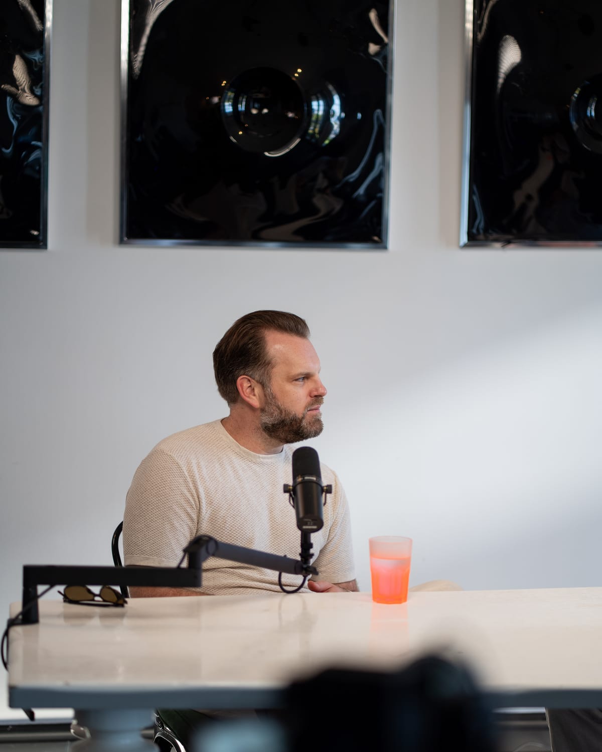 Matt Hammel sits at the podcast table looking toward the host while he takes in a question at Cannes Lions 2026