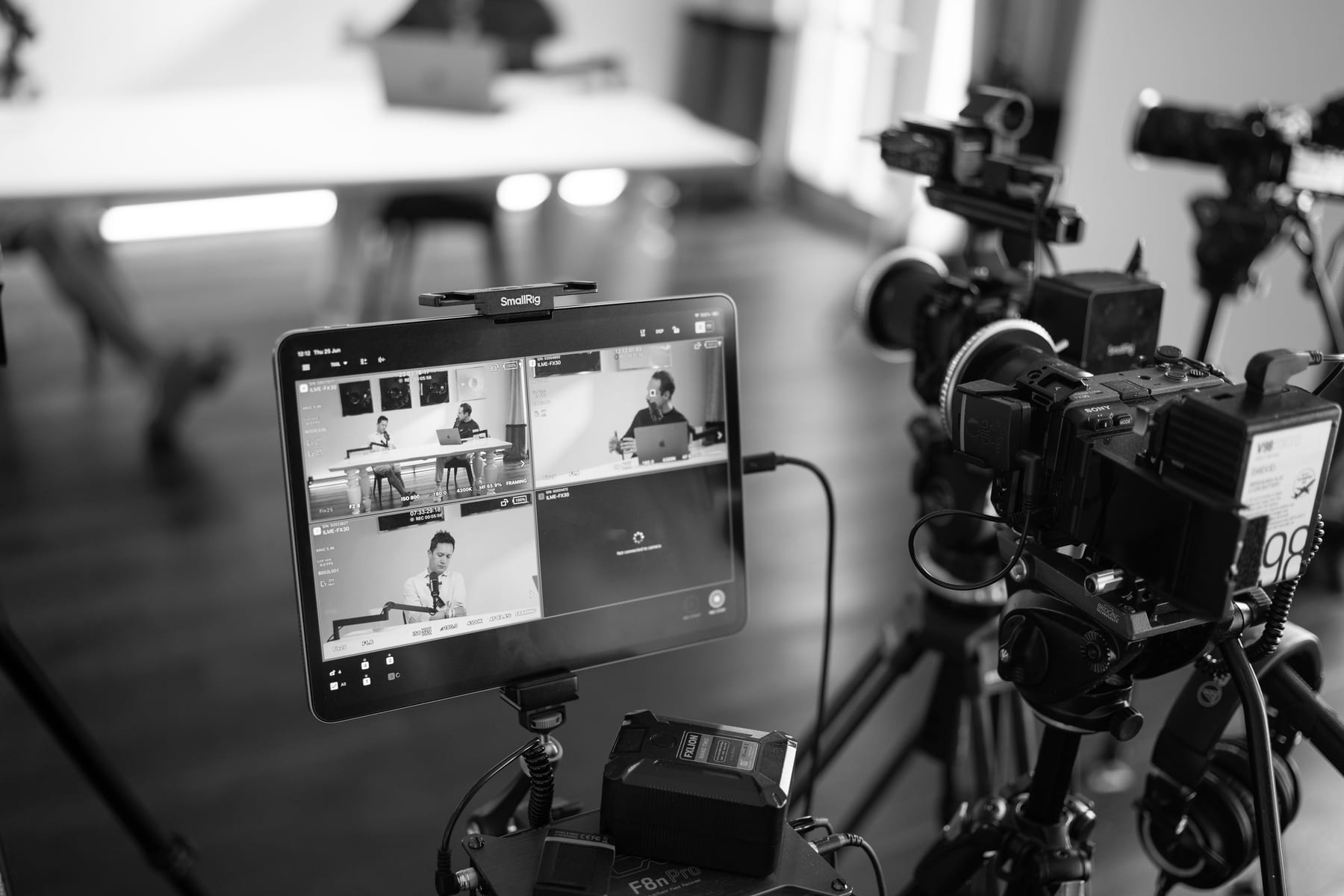 Black and white close-up of camera rigs and a monitor showing the podcast recording in progress at Cannes Lions 2026.
