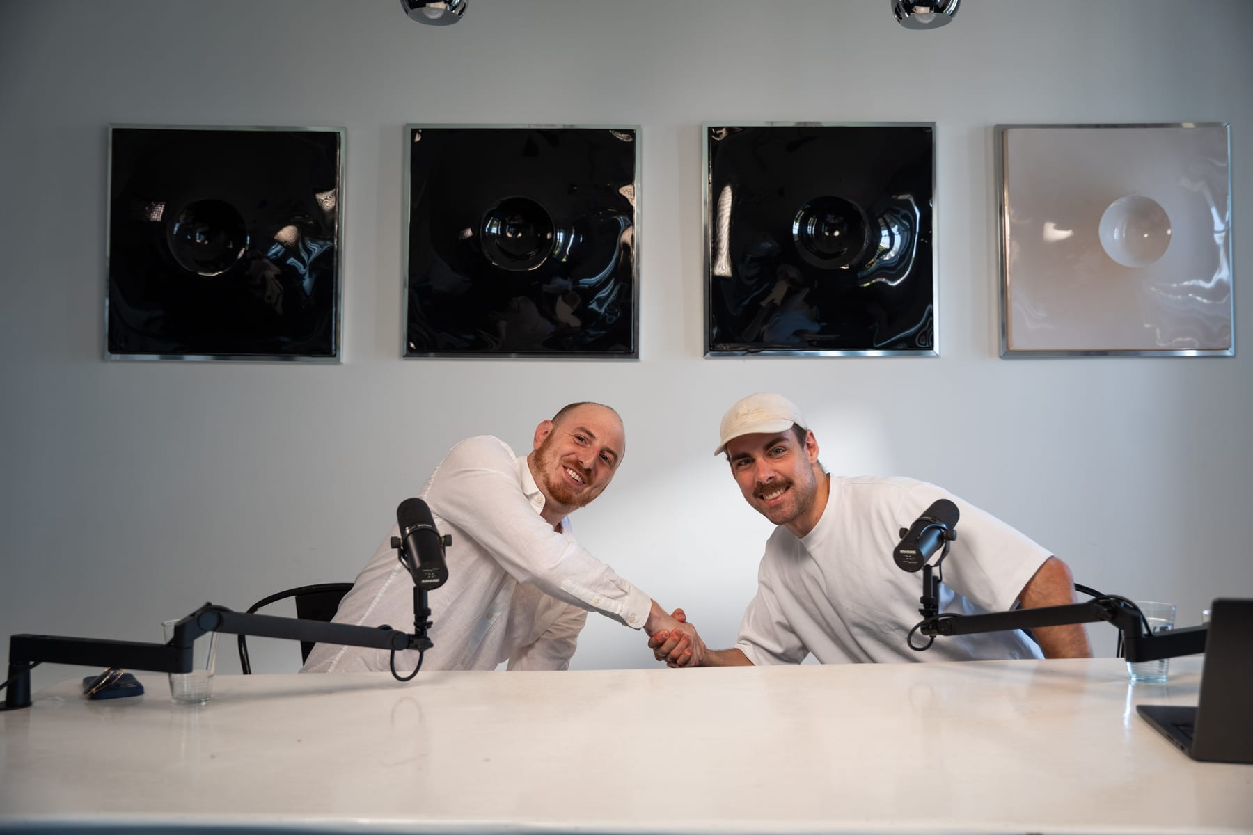 Noah Plaue and the host lean toward each other and laugh across the podcast table at Cannes Lions 2026