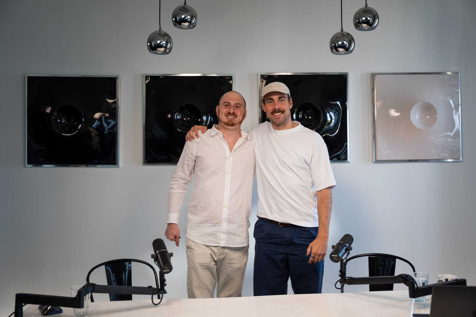 Noah Plaue and the host stand side by side in front of the podcast table after the recording at Cannes Lions 2026