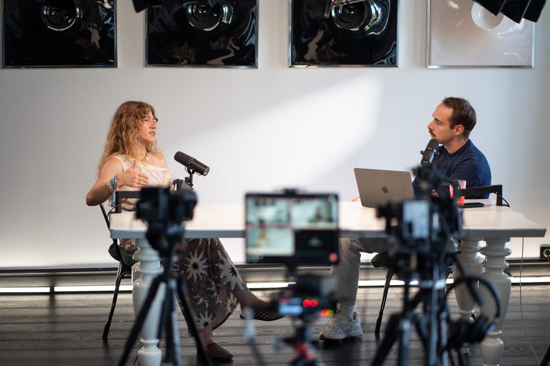 Meredith Smith and the host in conversation at a white table, seen past studio cameras at Cannes Lions 2026
